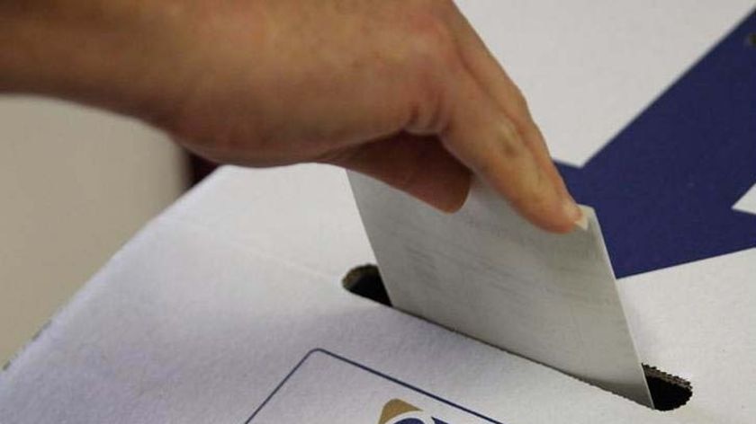 A vote being placed in a ballot box