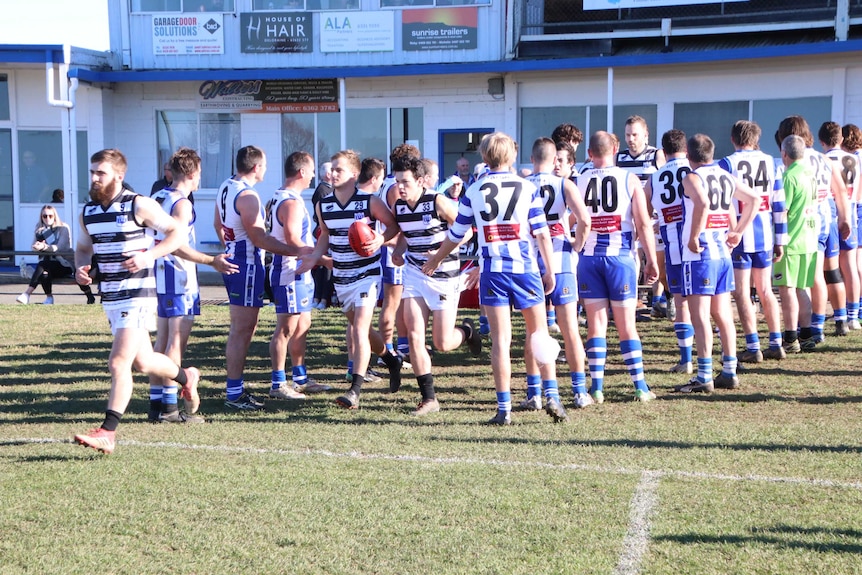 A football team runs onto the field.