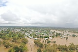 A small town seen from above covered in flood water.