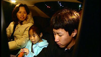 Freed: Janie and Ian Hwang leave the Villawood detention centre with their mother.