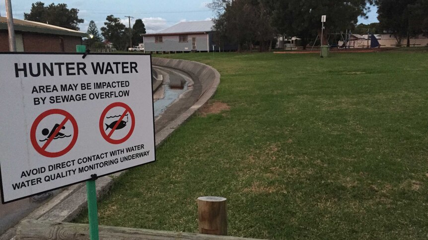 A sign warning about sewage at Waratah Park