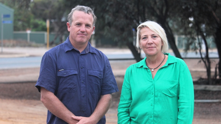 The two farmers stand in Salmon Gums and look at the camera