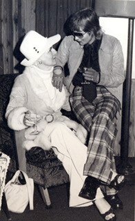 A black and white photo showing Rose Black sitting on the knee of Perth brothel madam Shirley Finn.