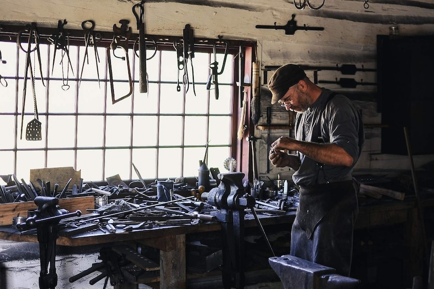 A craftsman with tools in a shed for a story about upcycling