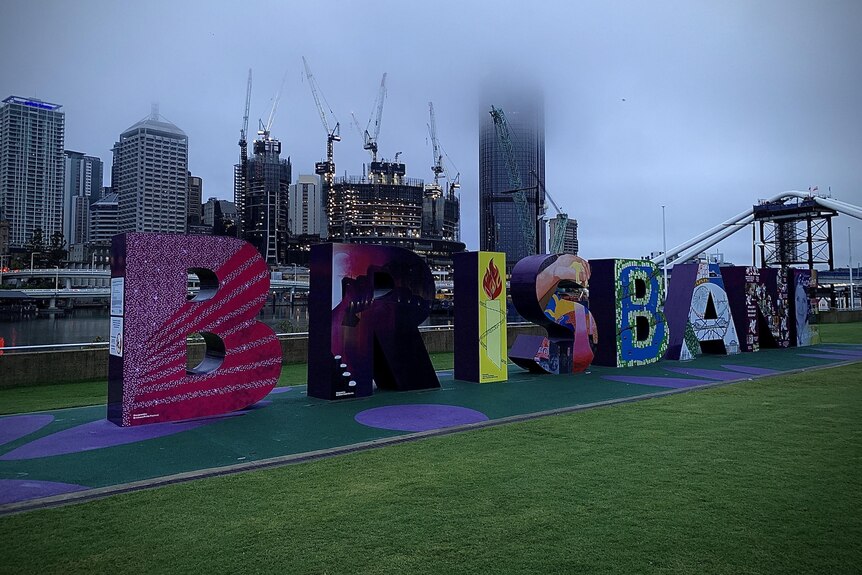 Rain clouds obscure the city behind the Brisbane sign at South Bank