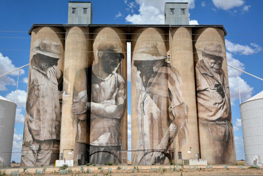 Murals of rural figures cover the side of 30-metre high silos in the rural town of Brim.