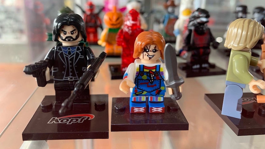 Two angry-looking Lego figurines with weapons including gun and sword.