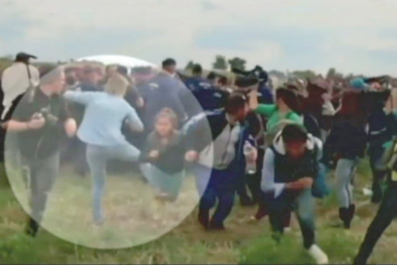 Hungarian camerawoman kicks asylum seekers