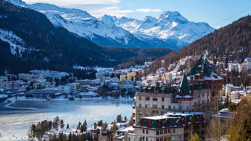 scenic picture of Saint Morits with grand hotels on the lake with alps in background