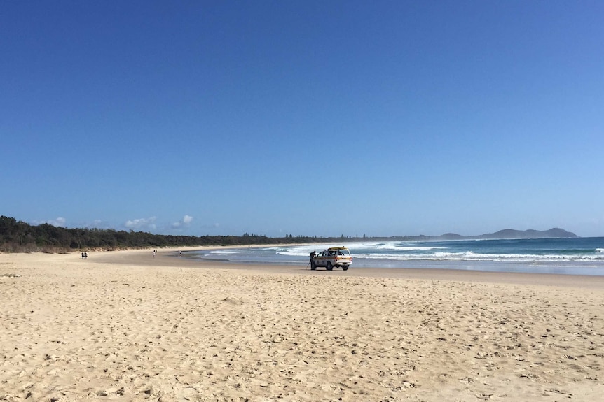 An emergency service vehicle on the beach.