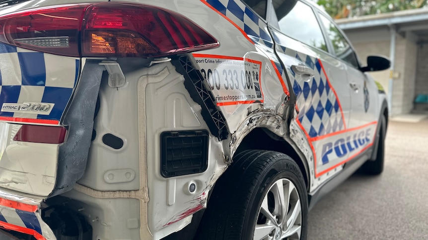 A police car with a missing back panel and significant damage