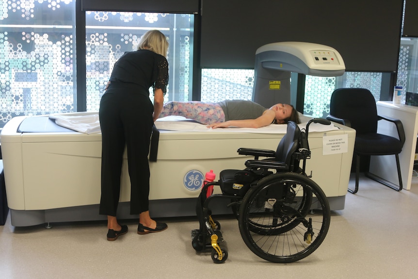Scarlett Halliday lays on a machine that tests bone density