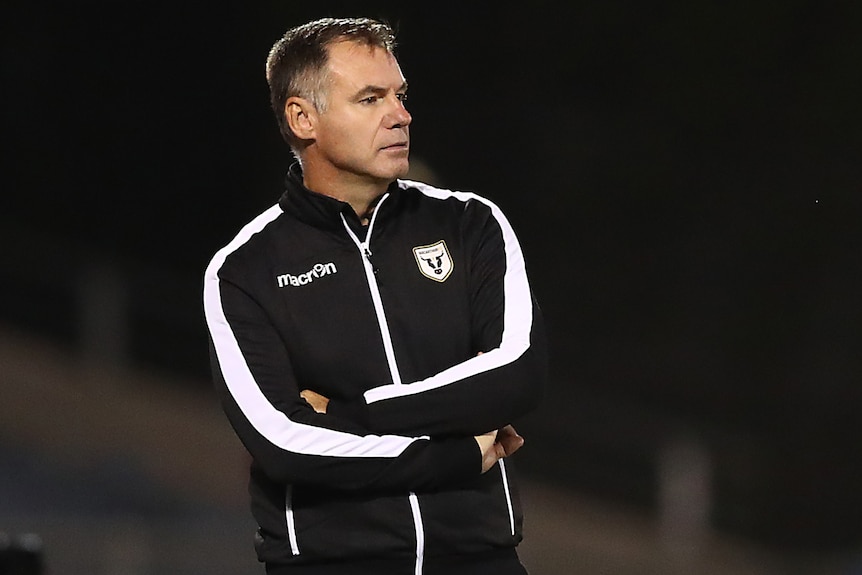 An A-League Men head coach on the sidelines during a match in 2021.