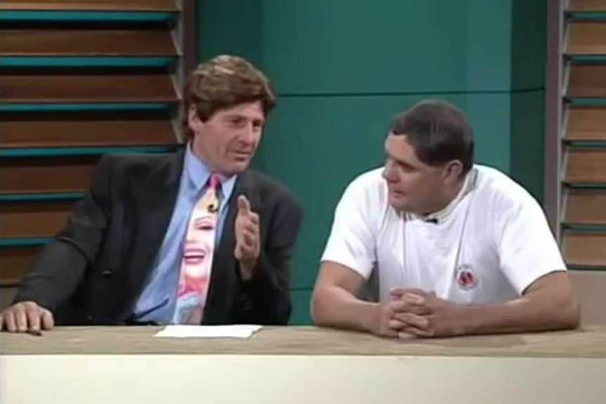 Two men sit on the set of The Footy show.