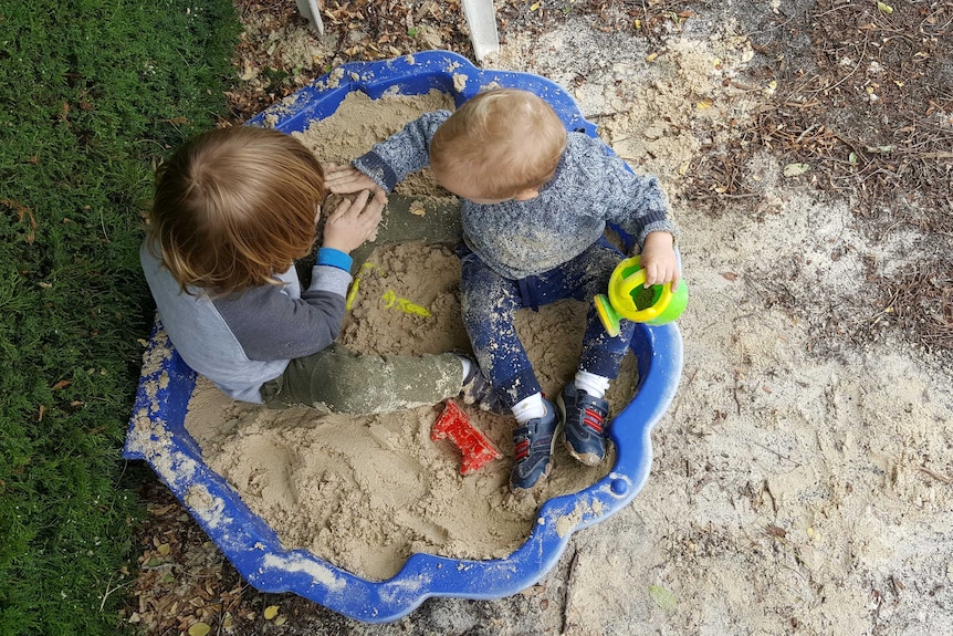 Marion's boys William and Alexander play in the sand