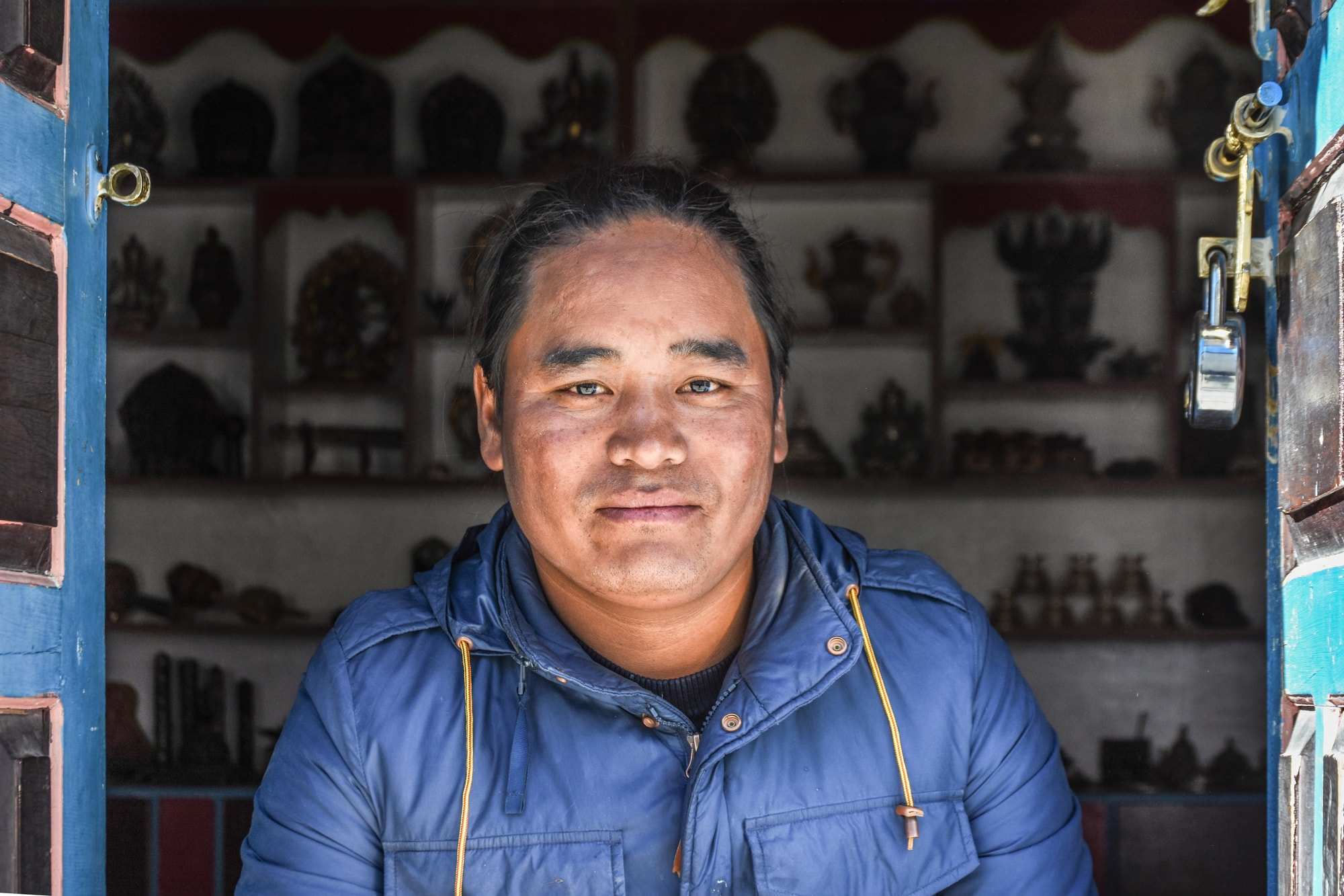 A close-up portrait of a man in a souvenir shop