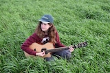 Aimee Gladigau playing her guitar