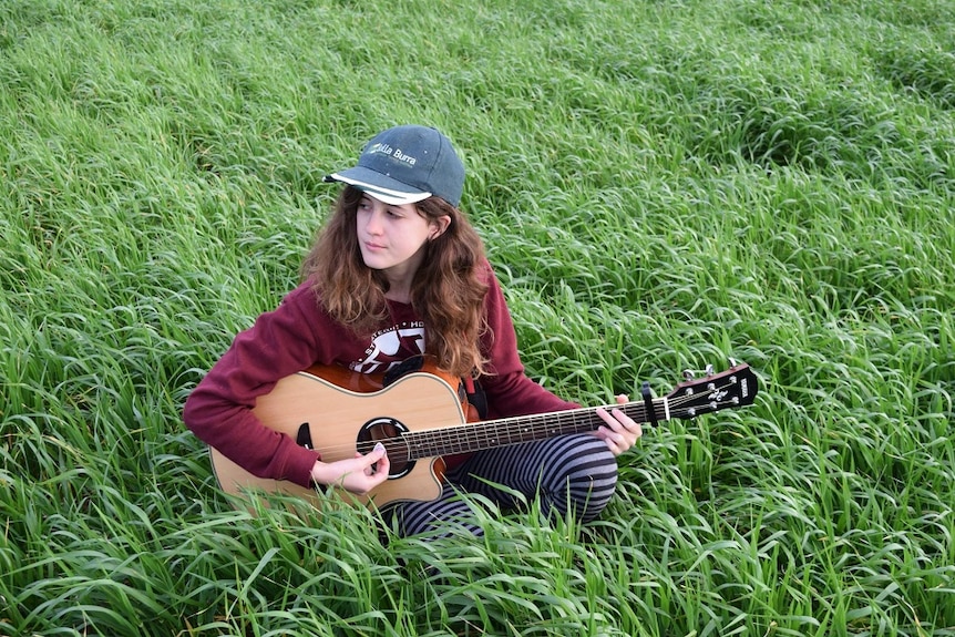 Aimee Gladigau playing her guitar