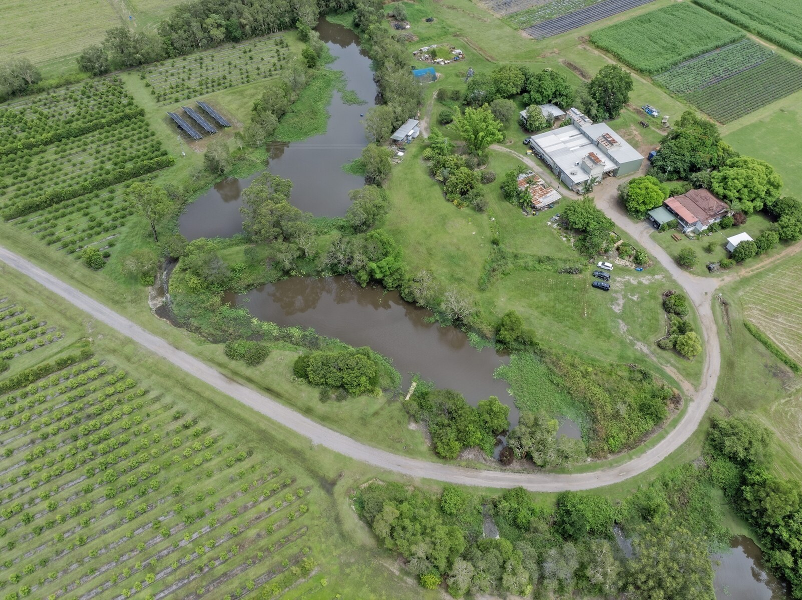 An aerial of the farm, showing the crops, dams, solar farms, sheds and house.
