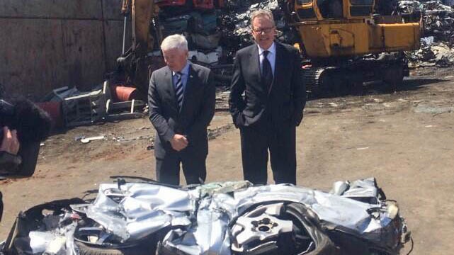 Ministers John Rau and Michael O'Brien with a car which was seized from a hoon driver and crushed.