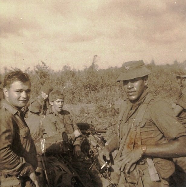 A sepia-toned photo of three men in army greens.