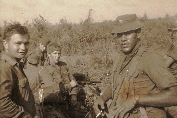 A sepia-toned photo of three men in army greens.