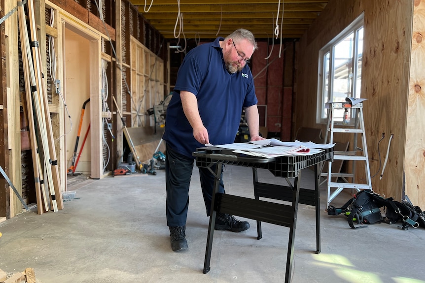 Gabriel Barnes looking at construction plans.