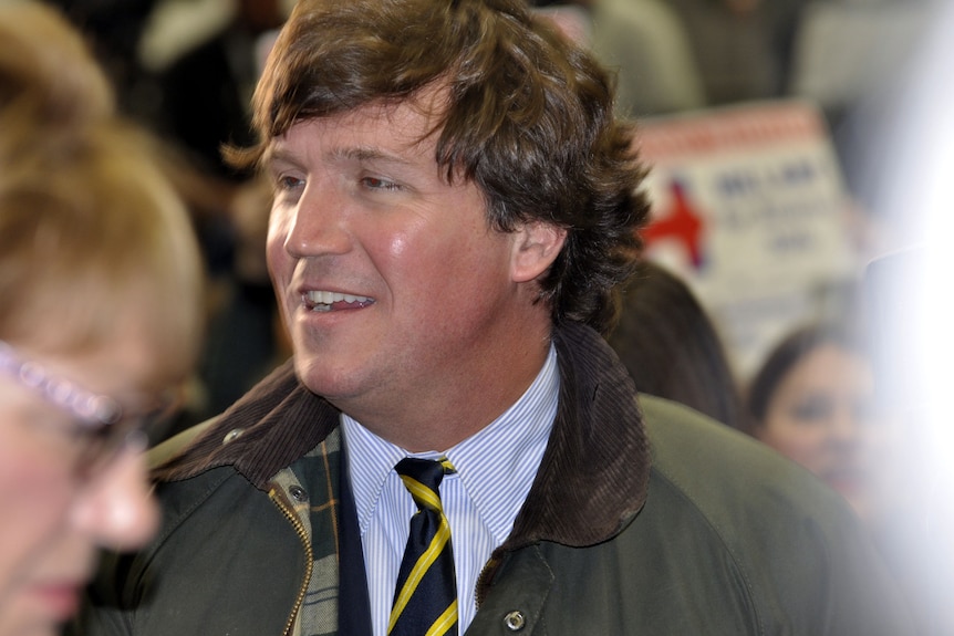 Tucker Carlson in a tie and jacket 