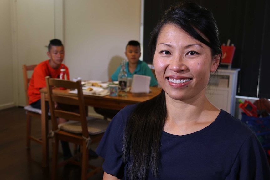 Jo Tan, with her boys in the background