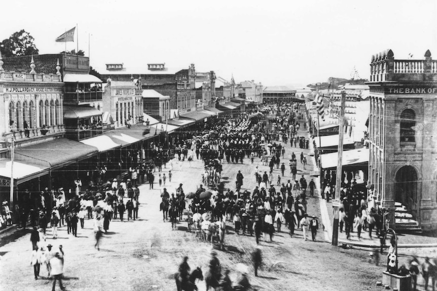 Black and white photo showing the procession in Flinders Street, Townsville 1888.