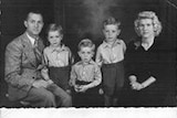 A black-and-white image of a family and a Christmas message