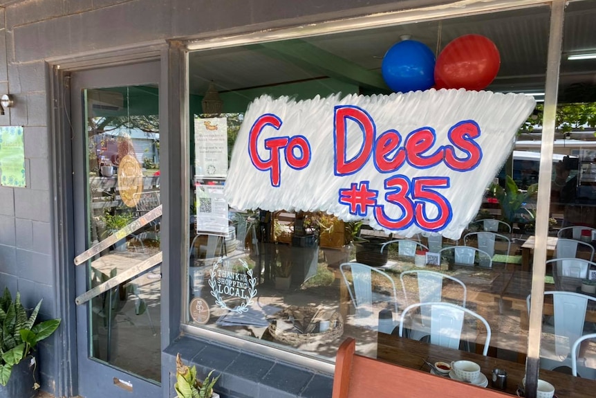 A cafe window with the sign 'go dees'