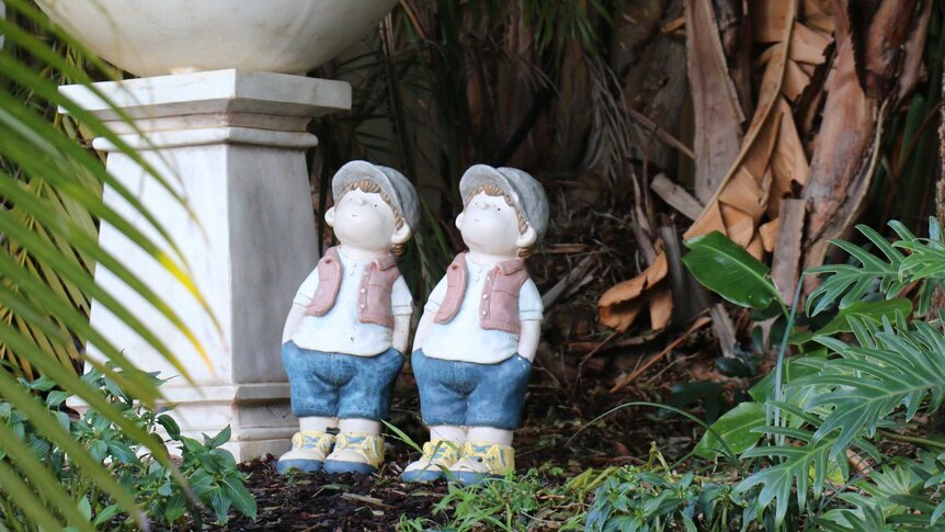 Two statues in a garden