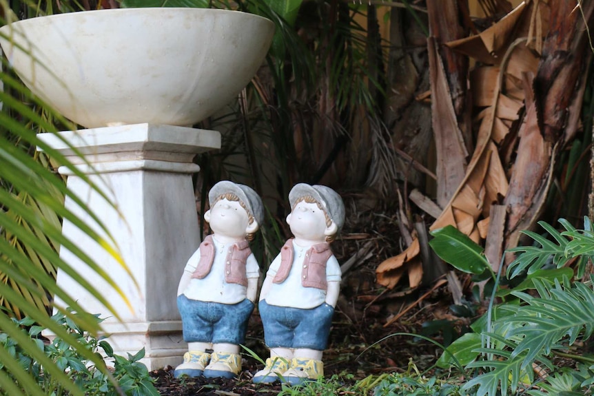 Two statues in a garden