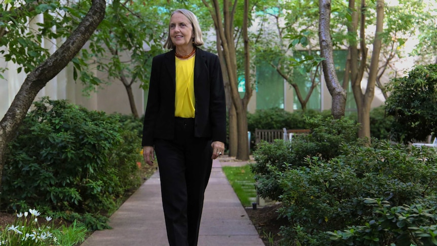 Lee Rhiannon walks in the grounds of Parliament House.