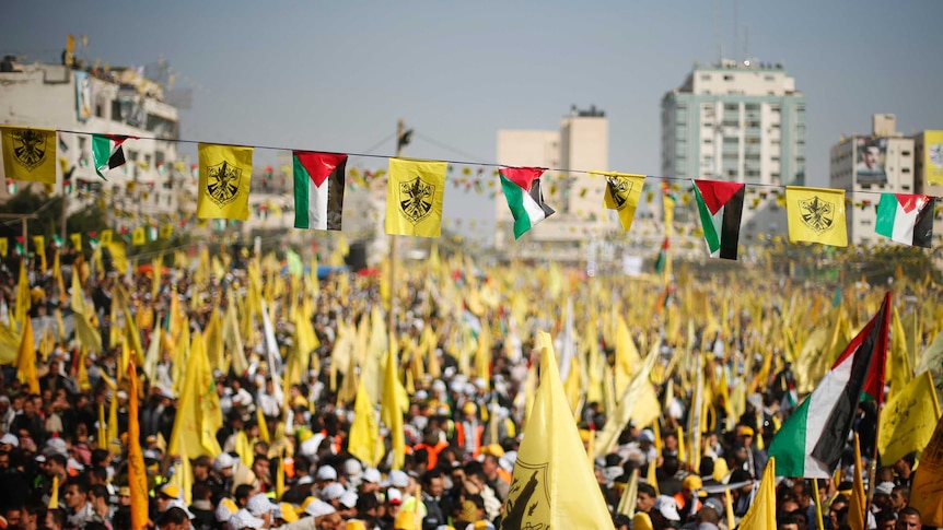 Palestinians take part in a rally marking the 48th anniversary of the founding of the Fatah movement.