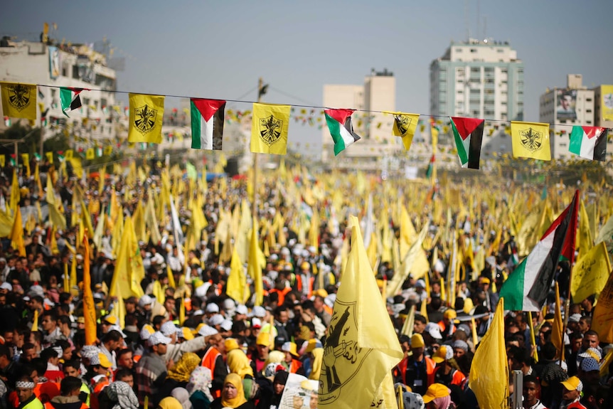 Palestinians take part in a rally marking the 48th anniversary of the founding of the Fatah movement.