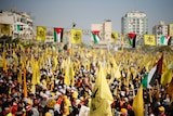 Palestinians take part in a rally marking the 48th anniversary of the founding of the Fatah movement.