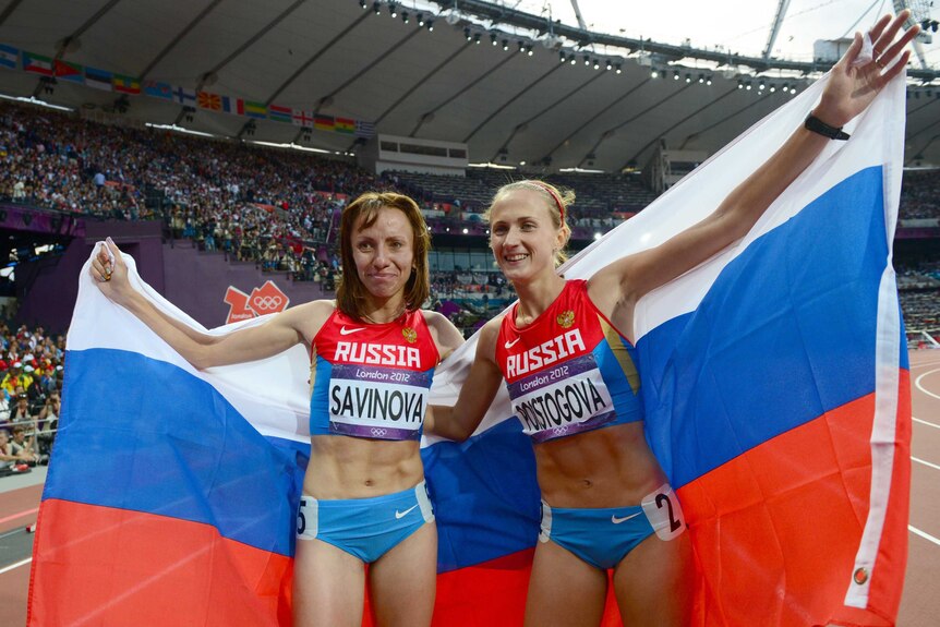 Russia's gold medalist Mariya Savinova (left) celebrating with Russia's bronze medalist Ekaterina Poistogova