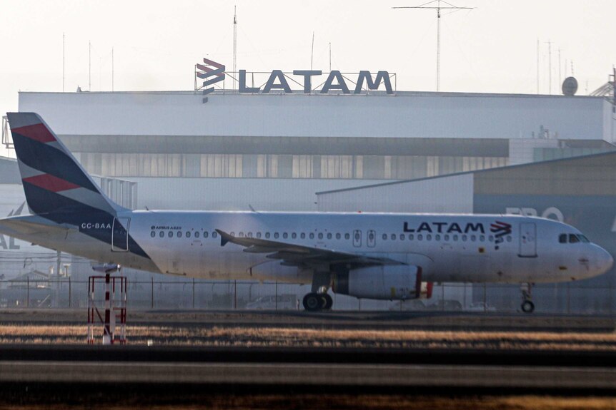 A LATAM airplane sits parked at the Arturo Merino Benitez airport in Santiago.