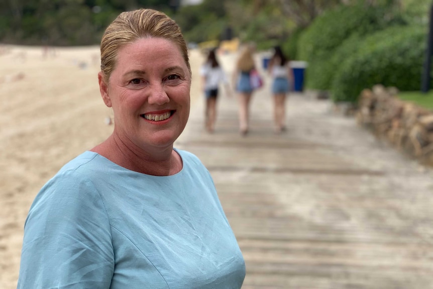 Woman standing on boardwalk at beach