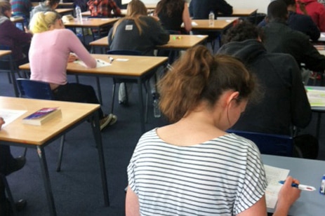 Students sit an exam.