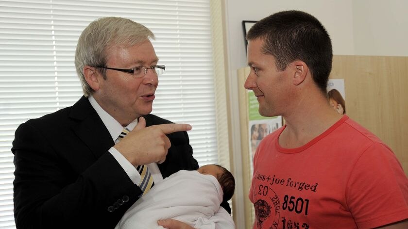 Kevin Rudd holds baby Tasha Woodford