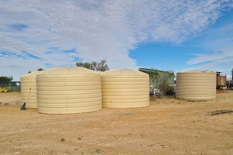 Four cream-coloured water tanks