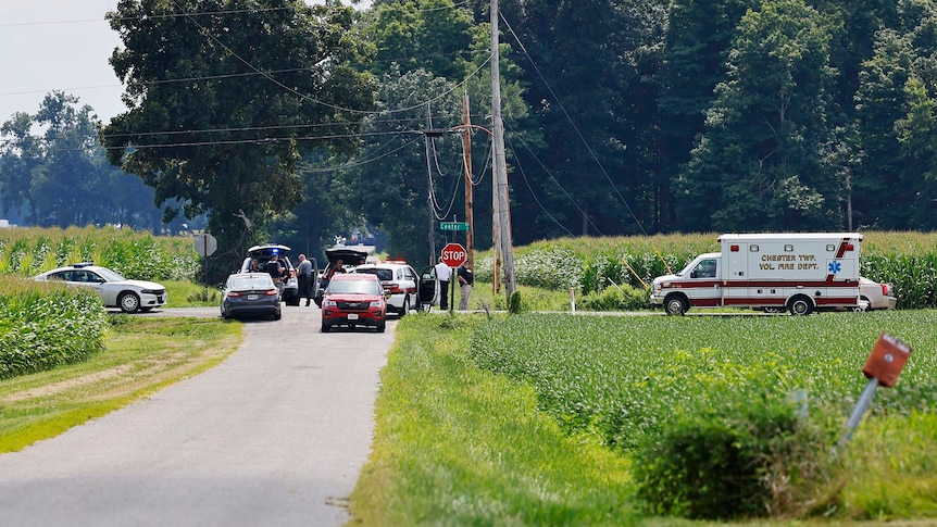 Cars pile up at an intersection as police vehicles close roads.