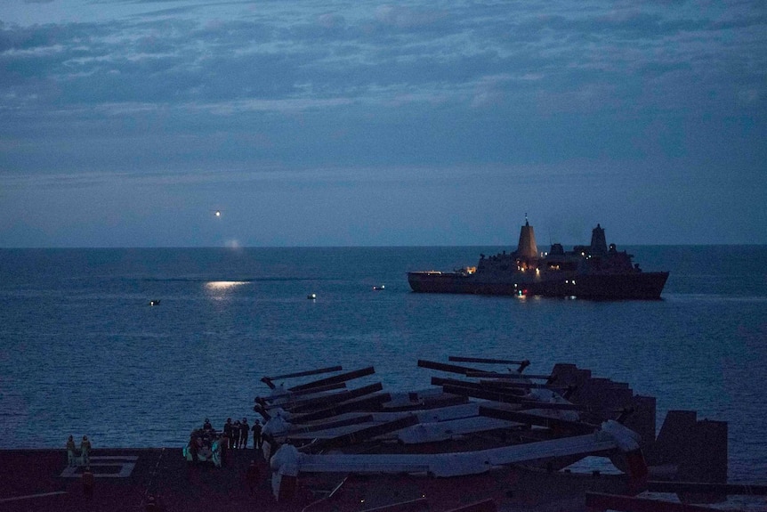 An aircraft shines a search light over a patch of water off the east coast of Australia.