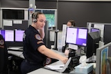 A woman in a police uniform answering the phone 