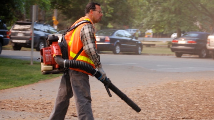Generic photo of man with leaf blower in a carpark