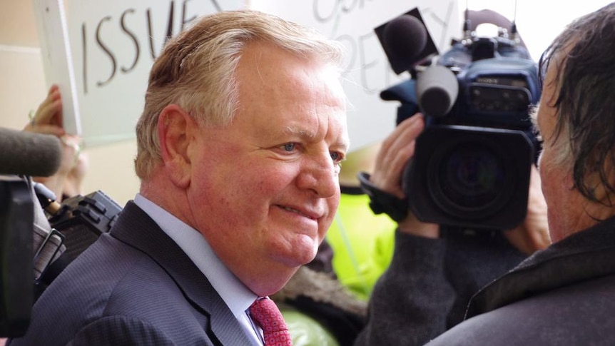 Close-up of Nigel Satterley talking to a person  at a protest outside Parliament House in Perth