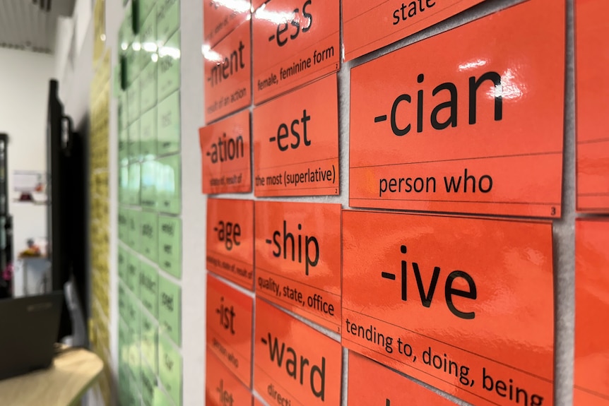 Small laminated bits of paper with phonics on them are seen in a classroom